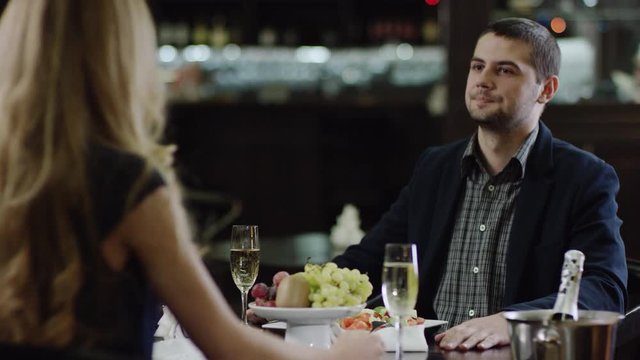 curling girl talking to partner at front in restaurant