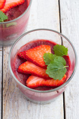 fruit pudding in glasses close-up on a white table.