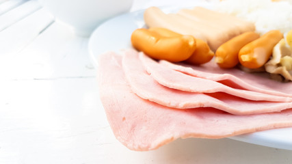 Ham and sausage mixed with rice on the dish