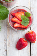 fruit pudding with chia and strawberries and mint on a table top view.