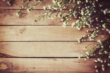 White flower on grunge wood board background with space.