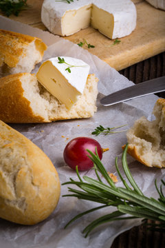 Cheese with white mold, radish, grapes and baguette with herbs
