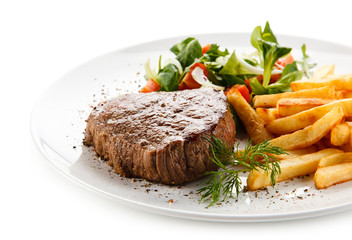 Grilled steak, French fries and vegetables 