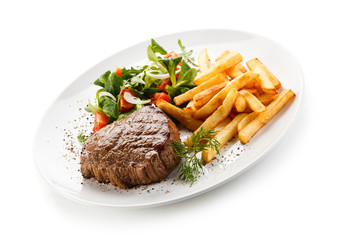 Grilled steak, French fries and vegetables 