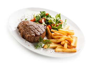 Grilled steak, French fries and vegetables 