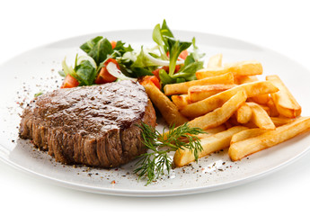 Grilled steak, French fries and vegetables 