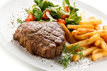 Grilled steak, French fries and vegetables 
