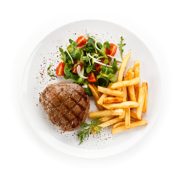 Grilled steak, French fries and vegetables 