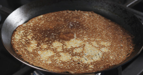 cooking blinis or pancakes on pan closeup shot, 4k photo