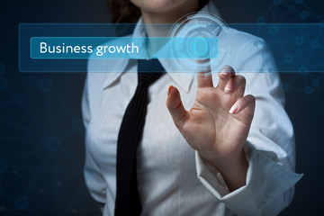 Business, technology, internet and networking concept. Business woman presses a button on the virtual screen: Business growth