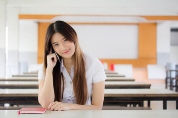 Portrait of thai adult student university uniform beautiful girl calling smart phone