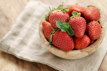 fresh strawberries in bowl on napkin on table, organic garden berries