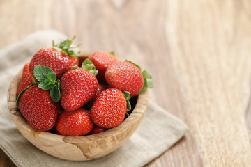 fresh strawberries in bowl on napkin on table, organic garden berries