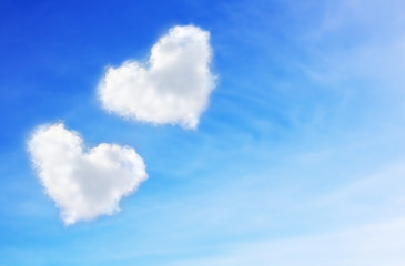 blue sky with hearts shape clouds. Valentine's holiday background