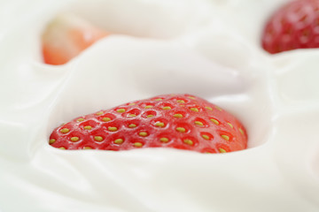 macro photo of organic yogurt with fresh sliced strawberries, food background