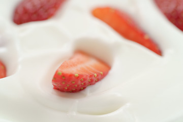 macro photo of organic yogurt with fresh sliced strawberries, food background