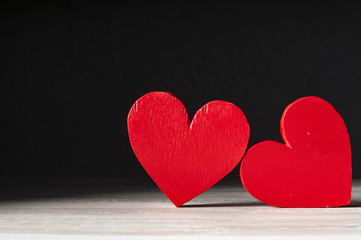 Obraz premium two hearts on dark wooden background