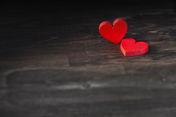two hearts on dark wooden background