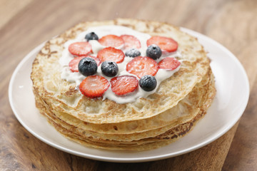 fresh blinis or crepes with fresh berries and cream, sweet food