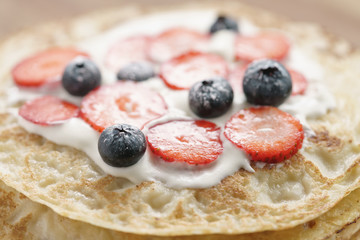 fresh blinis or crepes with fresh berries and cream, sweet food