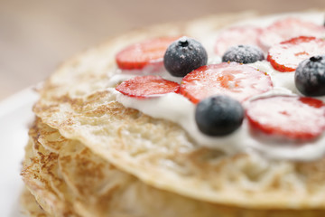 fresh blinis or crepes with fresh berries and cream, sweet food