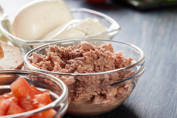 Ingredients ready for preparing bruschetta with tuna, mozzarella cheese and tomatoes