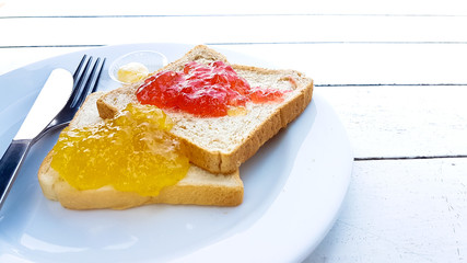 Toast with strawberry and orange yam on plate