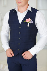 the groom's suit on a wedding. A vest and a buttonhole from a pink rose