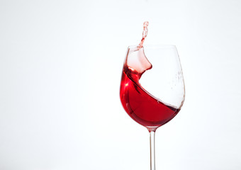 Bordeaux wine in the glass on a white background. The concept of beverages and alcohol.