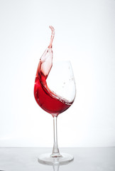 Wine in a glass on a white background. The concept of beverages and alcohol.