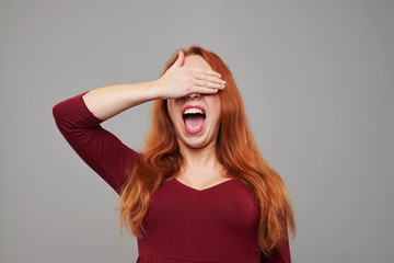 Surprised woman waiting for something with closed eyes