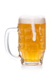 mug of light beer with foam on white.
