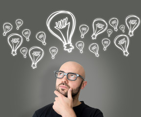 Young attractive bold with glasses man looking for idea