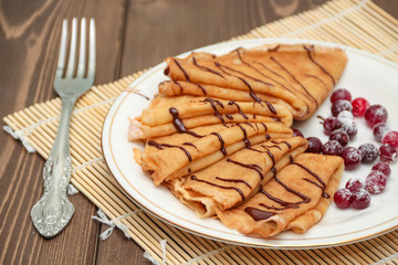 Pancakes with chocolate and berries