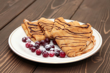 Pancakes with chocolate and berries
