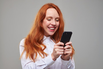 Fototapeta premium Happy youth holding mobile phone in hands