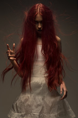 Red haired zombie woman in white cotton dress