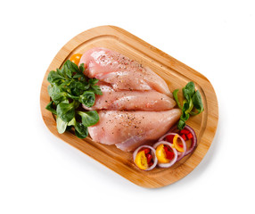 Raw chicken breasts on cutting board 