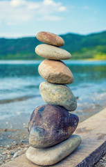 Photo of stones balanced on top of eachother on a beach
