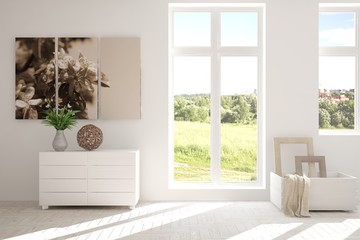Fototapeta na wymiar White room with shelf and green landscape in window. Scandinavian interior design