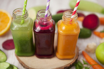 Freshly squeezed vegetable juice in bottles, useful vitamin cocktail, detox diet, selective focus