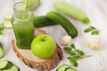Green Healthy smoothie and apple on white background