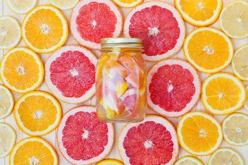 Fresh lemonade in a jar with slices of grapefruit, orange, lemon.