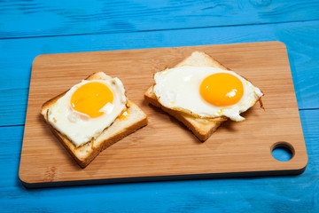 Toasts and egg on a blue wooden table