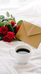 cup of coffee and a bouquet of red roses, envelope