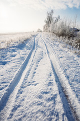 Fototapeta na wymiar Beautiful landscape with a road in the snowdrifts