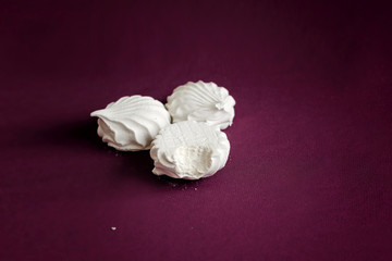 White marshmallow. Marshmallows on a cherry background. The sweetness of the tea. Airy meringue. Delicious dessert.