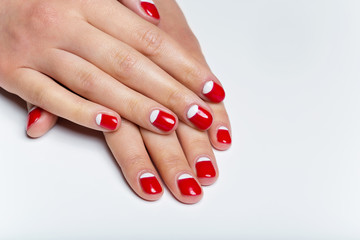 Female hands with red and white nails