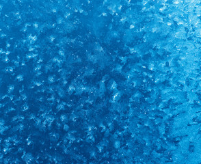 Beautiful abstract blue background is frosty pattern highlighted in blue.