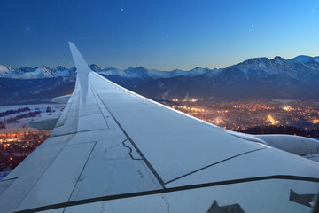 Fototapeta na wymiar View from the plane on a night city Zakopane